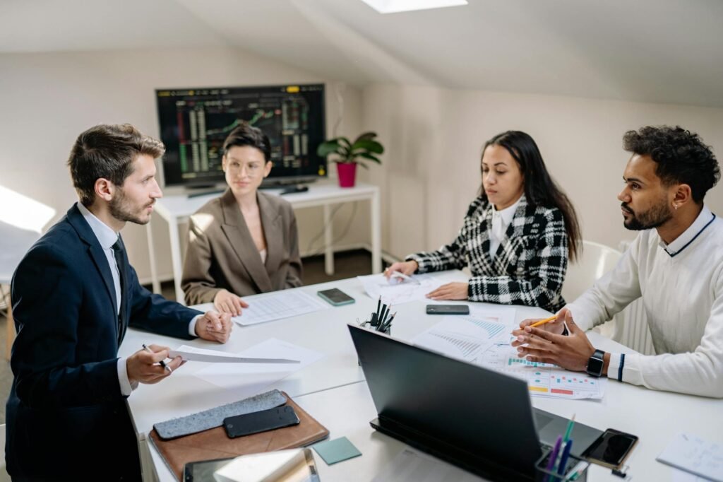 ai stock performance - business professionals analyzing screens professional business image