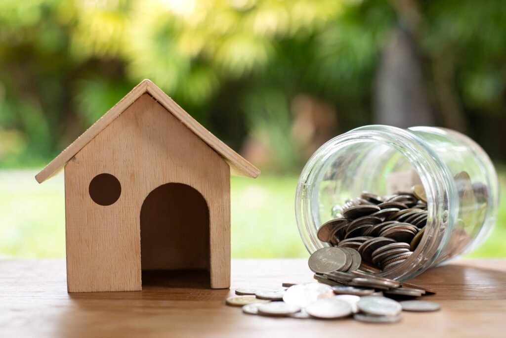 Home model with coin money stack, Saving money concept. Home buying.